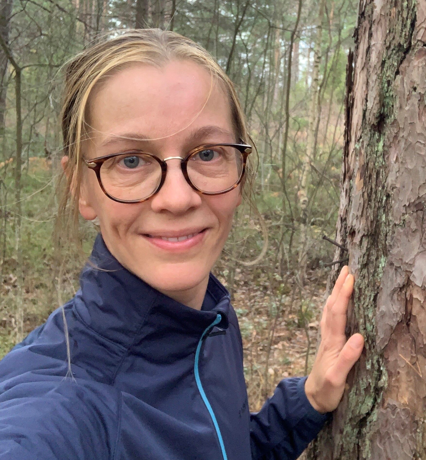 Johanna Toivonen next to an old pine tree