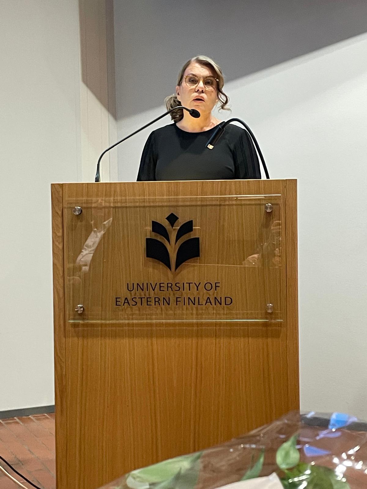 Katja Laakkonen standing behind a podium