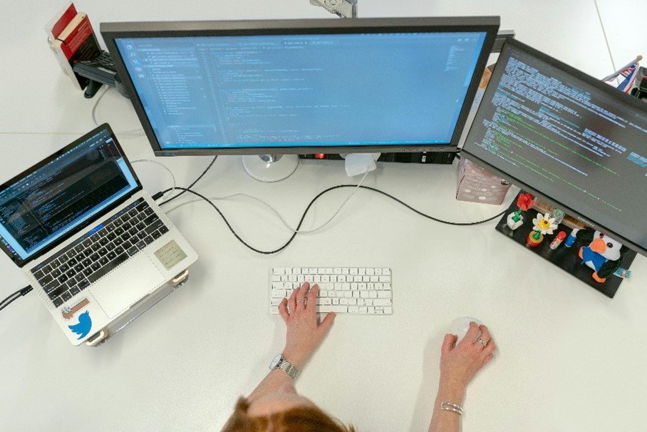 Decorative picture with a person working on multiple screens