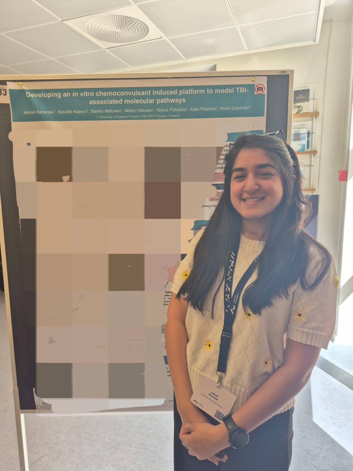 Meheli Banerjee in front of her poster