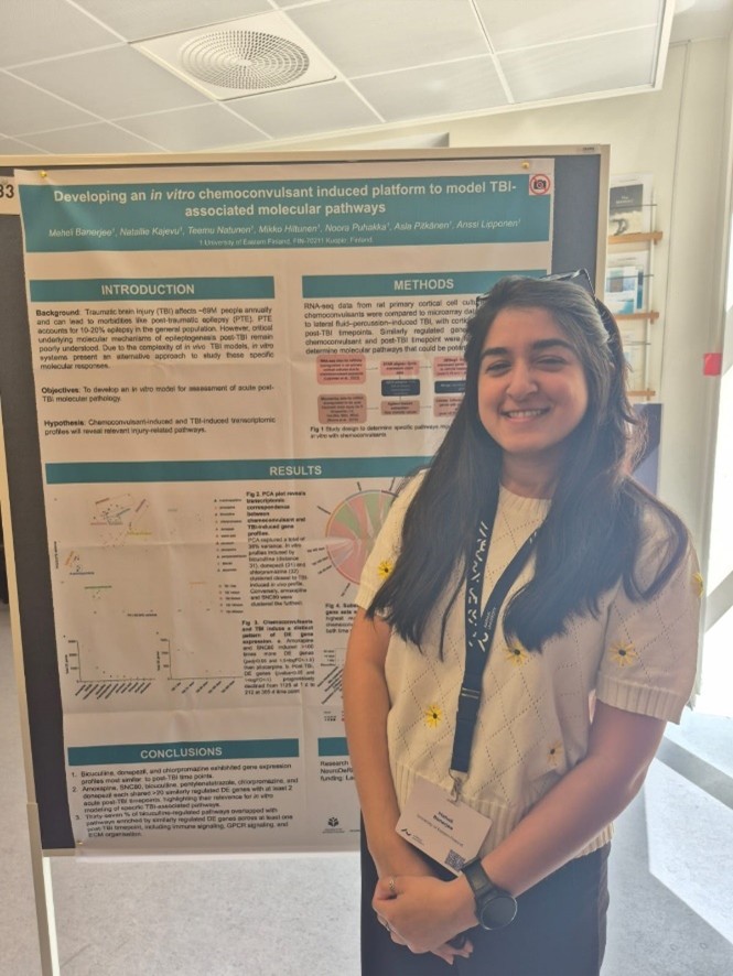 Meheli Banerjee in front of her poster