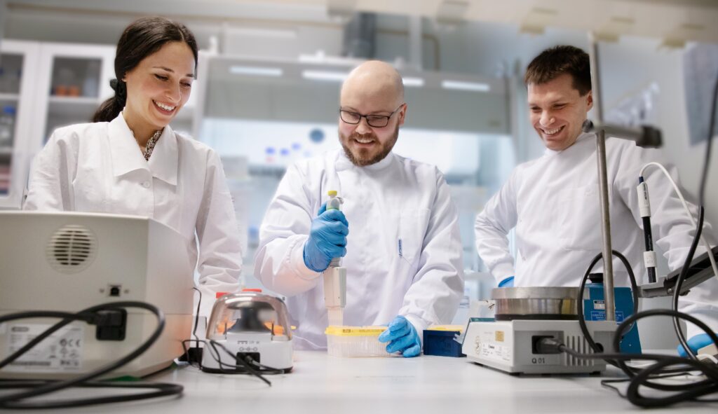 Researchers working in laboratory and being happy